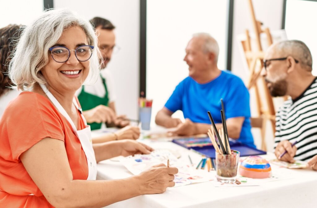 A group of older adults enjoy painting together.