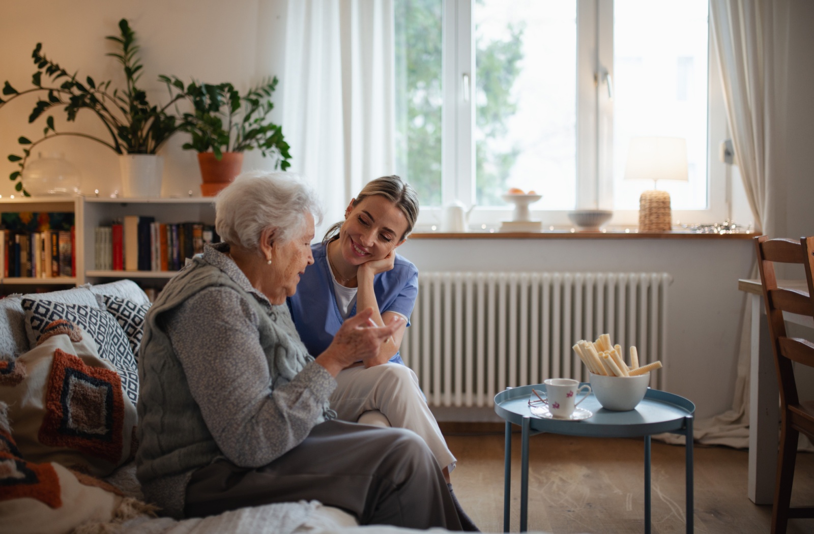 A caregiver listens to a senior in assisted living.